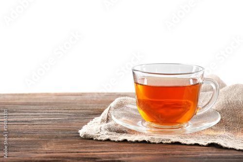 Glass cup of tea on wooden table