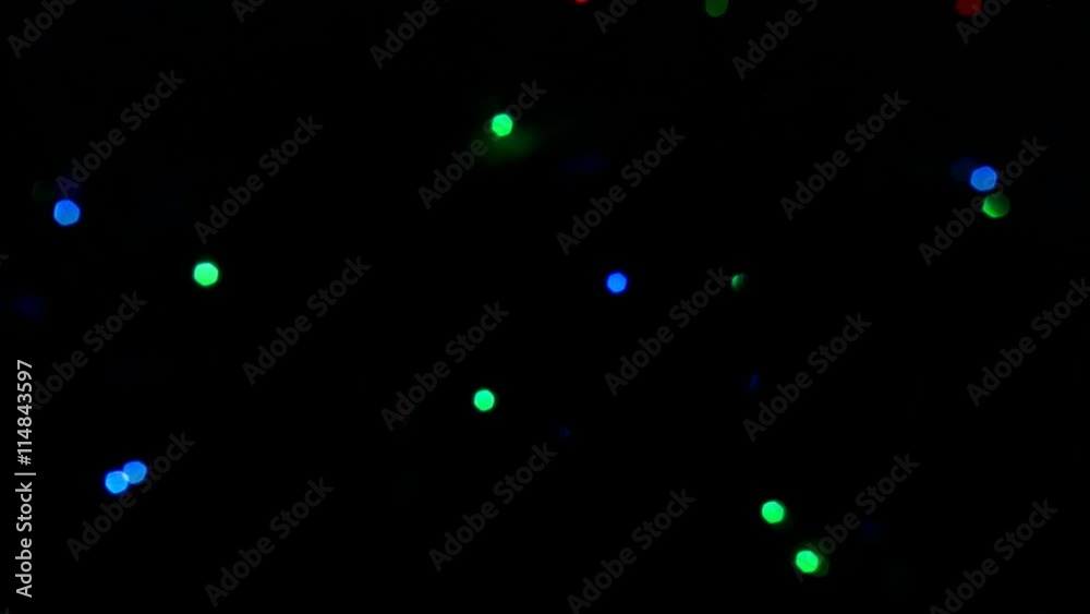 Small red, green, and blue lights flashing at random on a black frame Small red, green, and blue lights flashing at random on a black frame