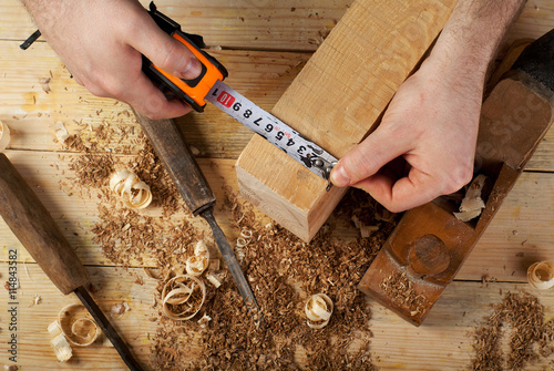 Carpenter working, hammer, meter and screw-driver on construction background
