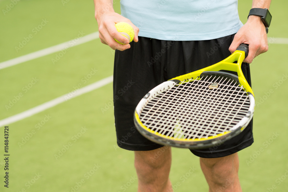 Skillful tennis player carrying the equipment