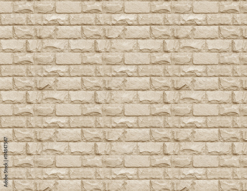 Seamless pattern of a beige stone wall 