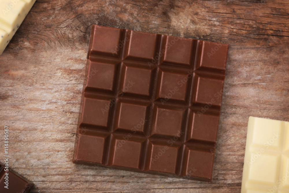 Fototapeta premium Chocolate bars on wooden background