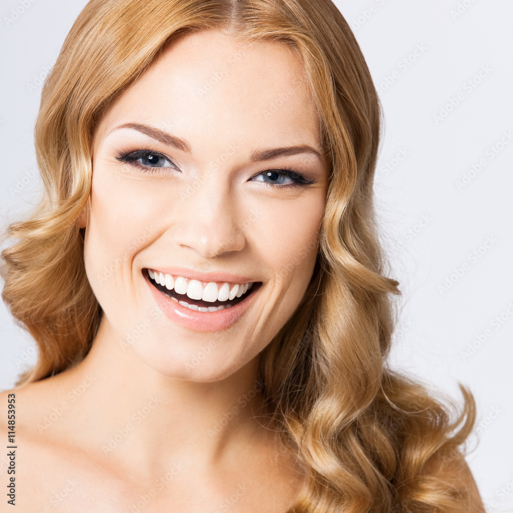 Young cheerful smiling woman, on gray Young cheerful smiling woman, on gray
