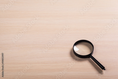 magnifying glass on the wooden background