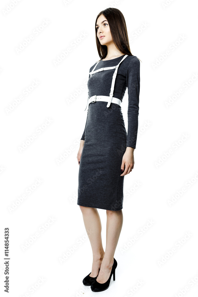 Attractive beautiful dark-haired woman wearing dress and belt on white background