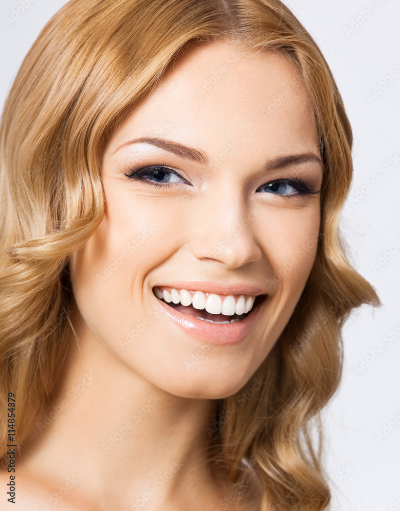 Young cheerful smiling woman, on gray Young cheerful smiling woman, on gray