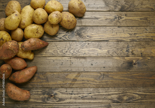 Yams and sweet potatoes on a reclaimed wood background 