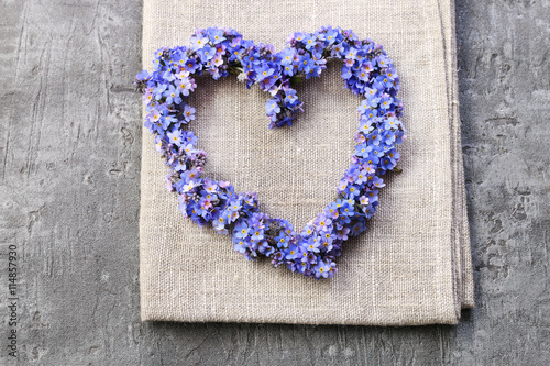Heart shaped wreath made of forget-me-not flowers.