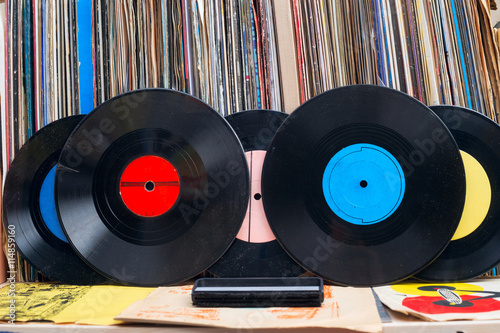Browsing through vinyl records collection. Music background. Copy space. Retro styled image