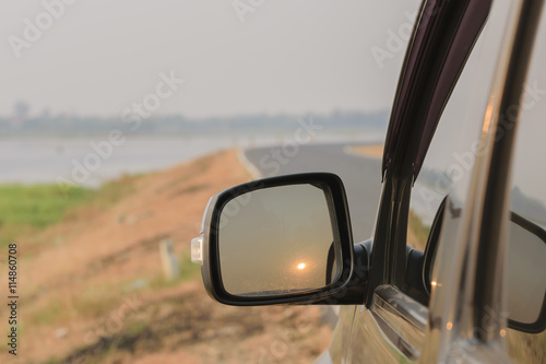 The car side mirror with sun reflections