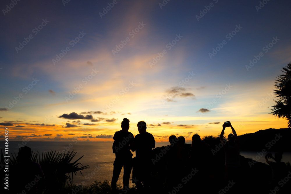 travelers watching sunset at Promthep Cave, Phuket, Thailand