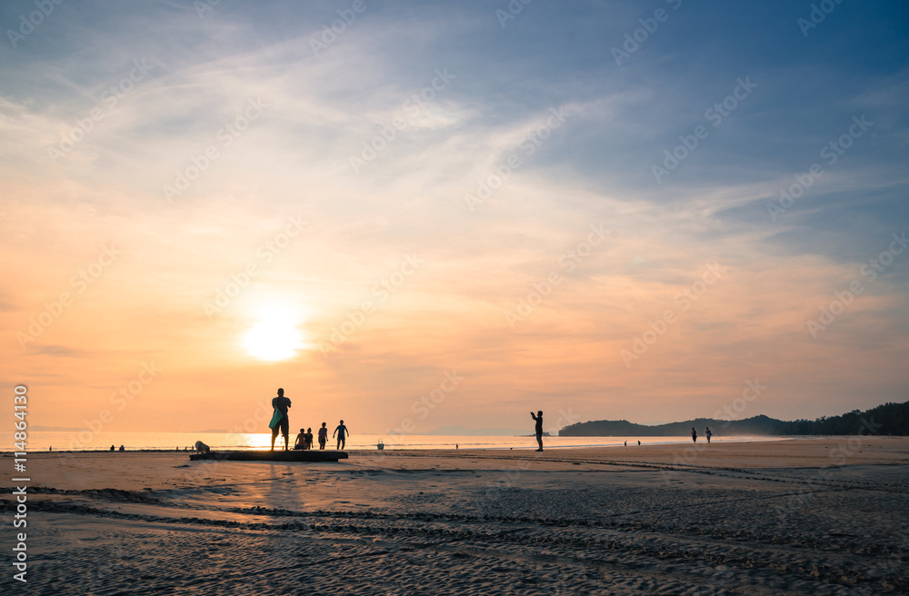 silhouette people relax on the beach with sunset silhouette people relax on the beach with sunset