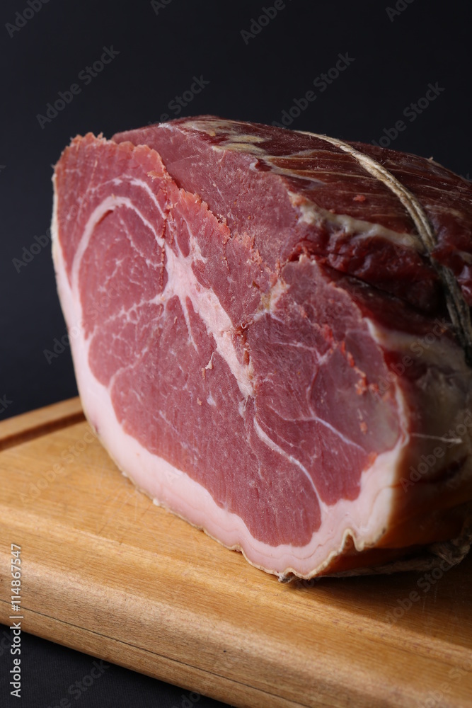 Fototapeta premium Piece of fresh red meat on wooden board. Close up