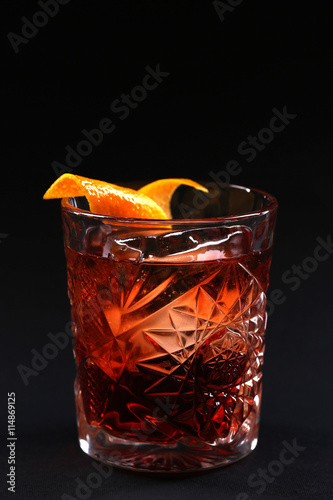 Old fashioned Negroni cocktail on the black background.