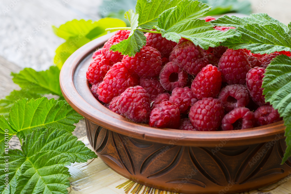 Fresh ripe raspberries on the wooden table Fresh ripe raspberries on the wooden table