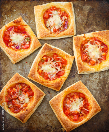 Puff pies with tomato, red onion and cheese