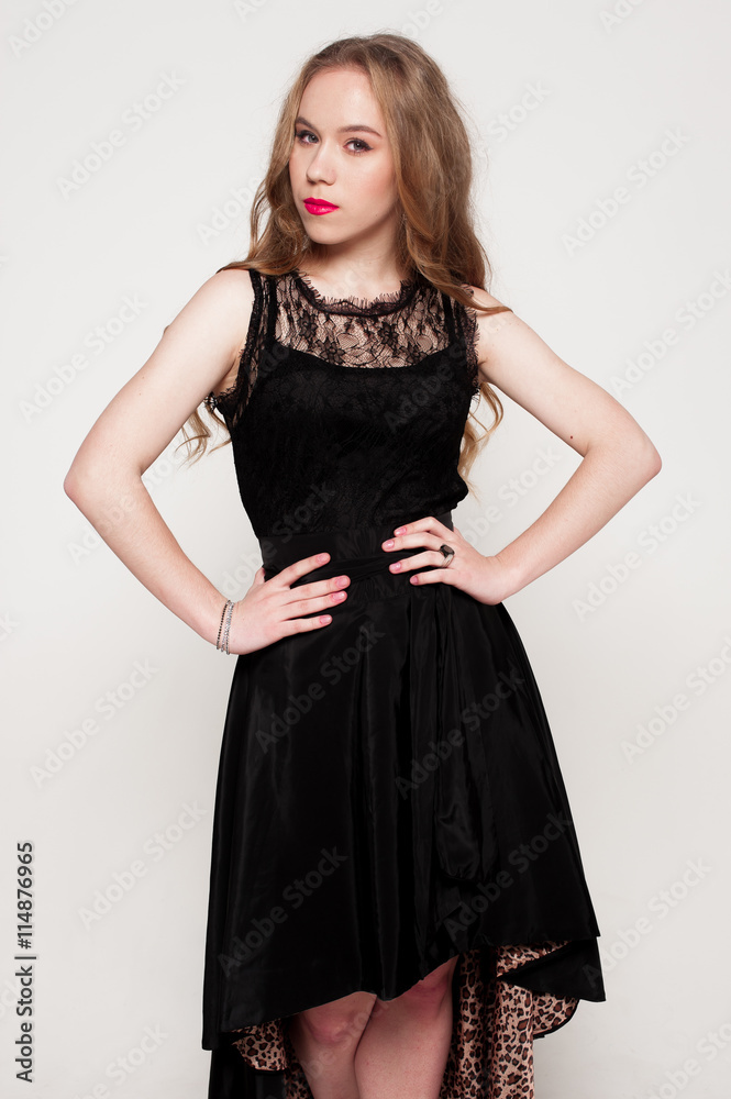 Portrait of beautiful young blonde girl in black dress. Fashion photo Portrait of beautiful young blonde girl in black dress. Fashion photo