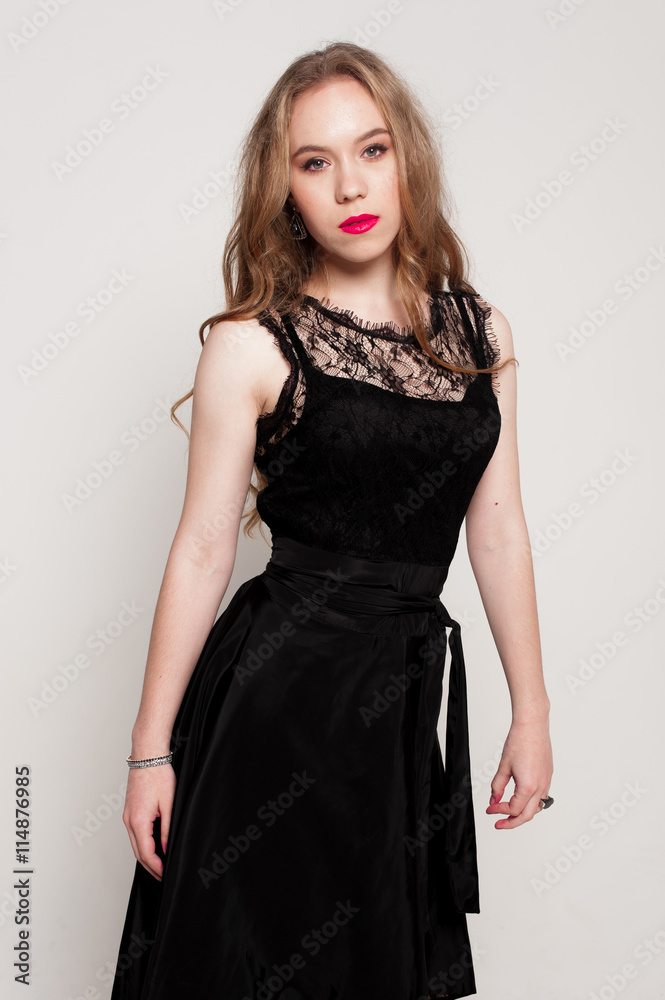 Portrait of beautiful young blonde girl in black dress. Fashion photo Portrait of beautiful young blonde girl in black dress. Fashion photo