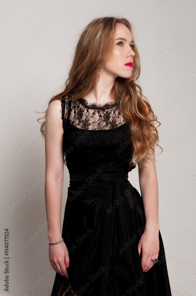 Portrait of beautiful young blonde girl in black dress. Fashion photo Portrait of beautiful young blonde girl in black dress. Fashion photo