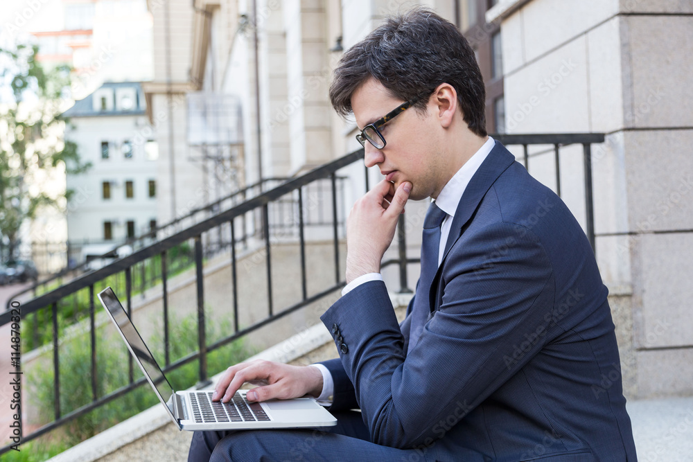 Thoughtful man using laptop Thoughtful man using laptop