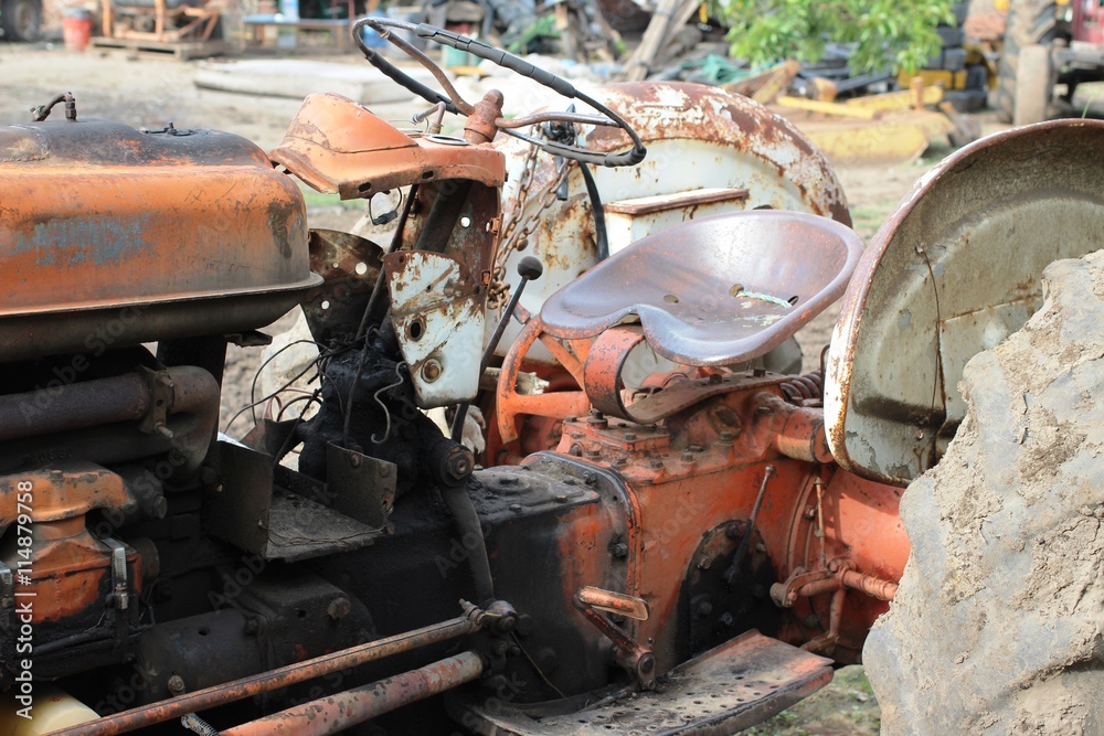 An old and dirty tractor that is abandoned An old and dirty tractor that is abandoned