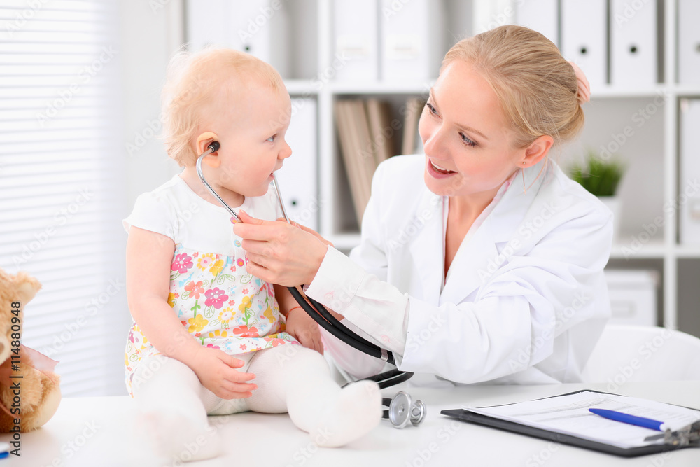 Fototapeta premium Happy cute baby after health exam at doctor's office