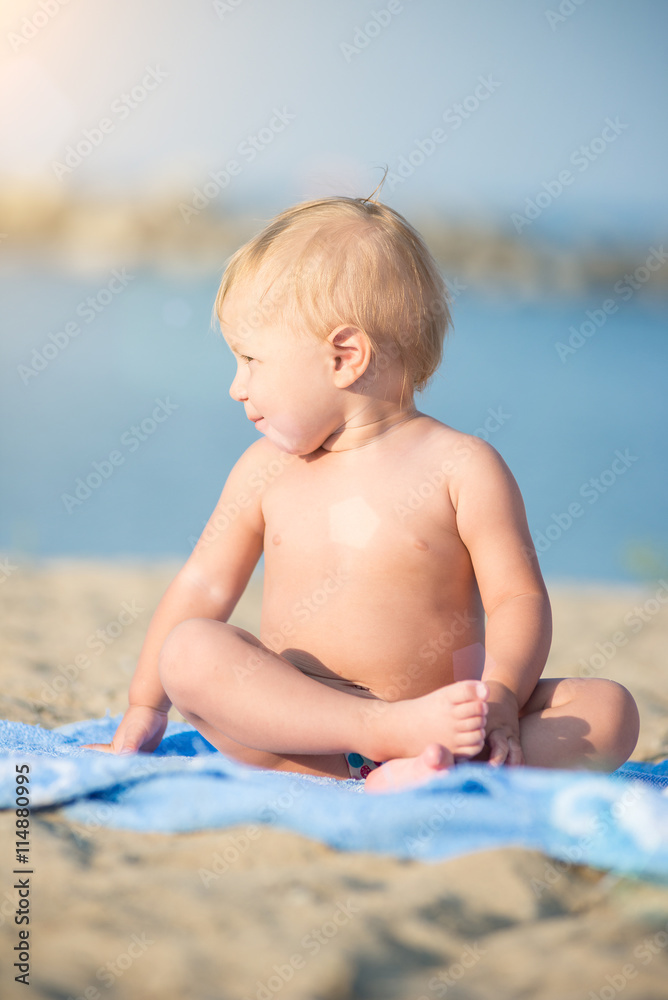 Baby playing with toys on the sandy beach near the sea. Cute little kid in sand on tropical beach. Ocean coast. Baby playing with toys on the sandy beach near the sea. Cute little kid in sand on tropical beach. Ocean coast.