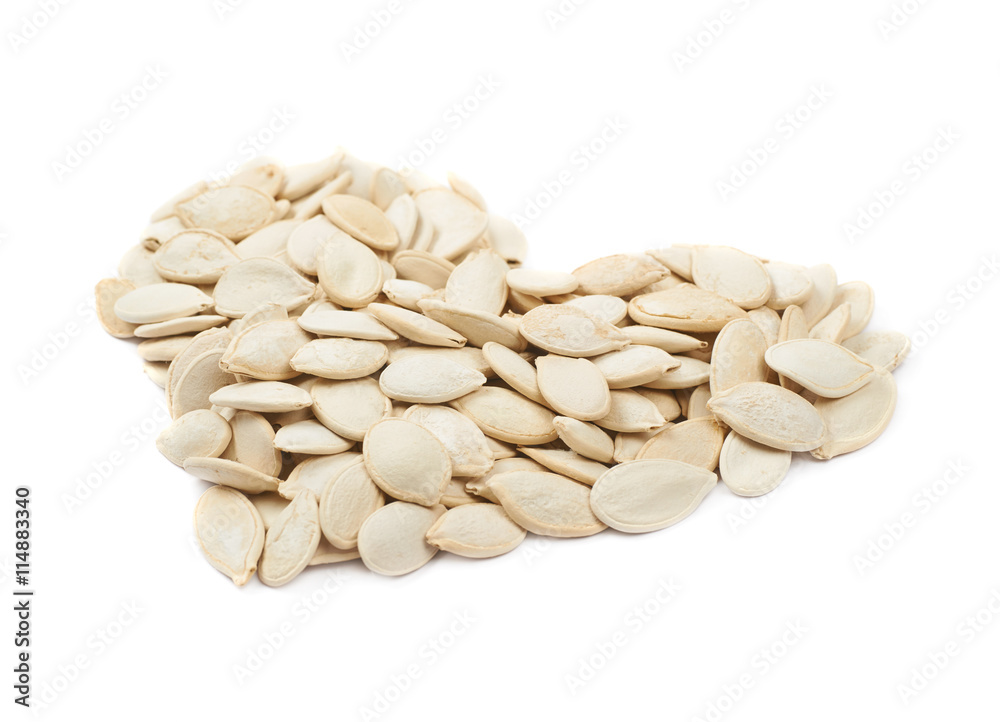 Heart shape made of pumpkin seeds isolated Heart shape made of pumpkin seeds isolated