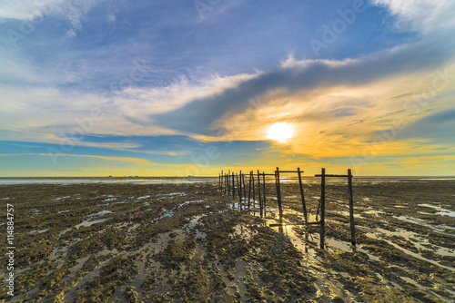 Wooden jetty with sunset background