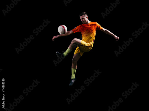 Professional soccer player in red kicking ball in jump © masisyan