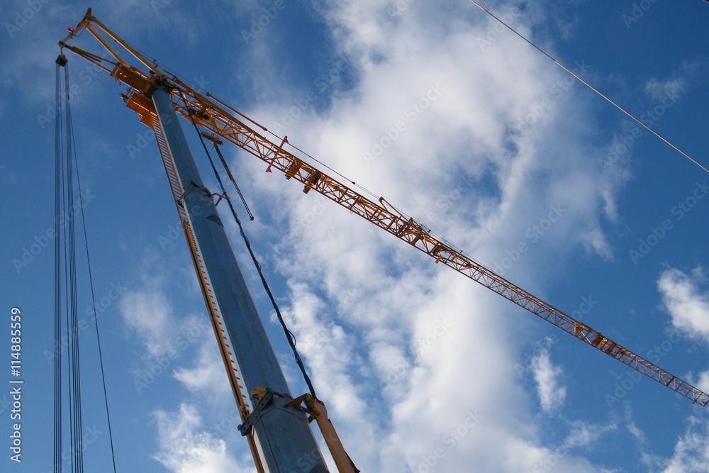 Yellow Crane with a Blue Sky and White Clouds