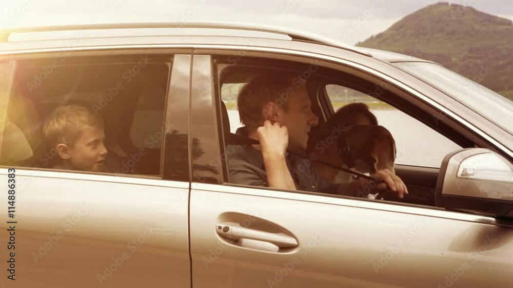 Family with their dog get in a car, fasten their seat-belts and set off