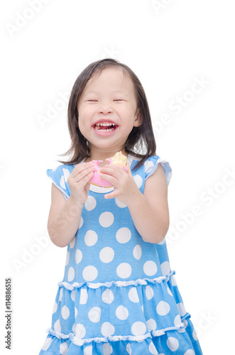 Little asian girl eating donut over white background