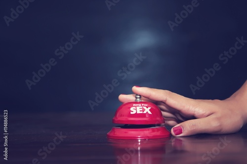 woman's hands press sex bell on a reception bell. concept about photo