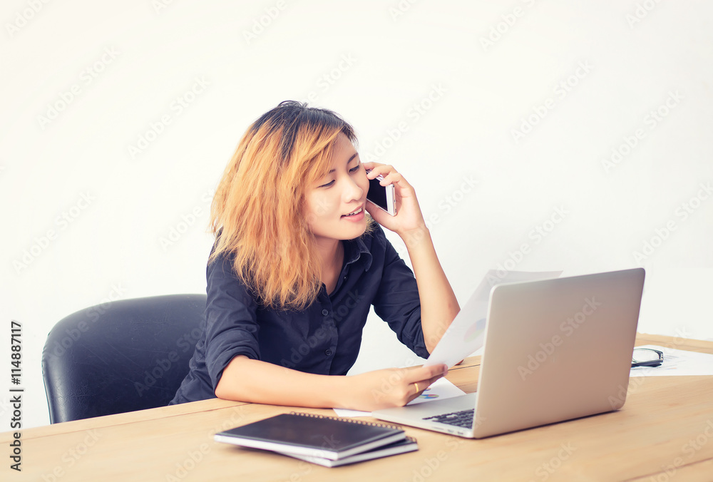 businesswoman talking on the phone in office. businesswoman talking on the phone in office.