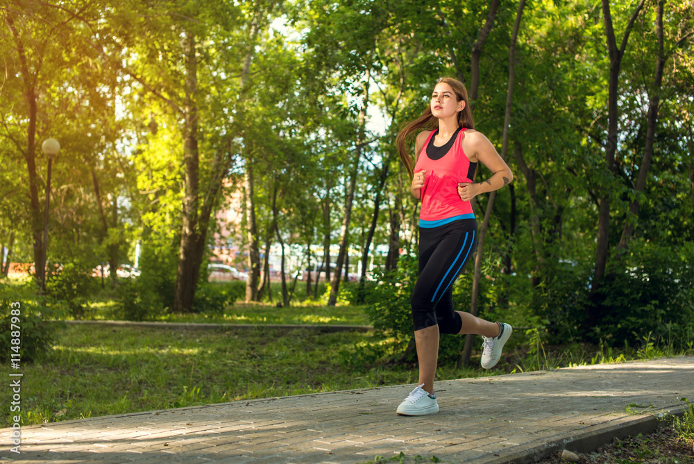 Running woman in park in summer training Running woman in park in summer training