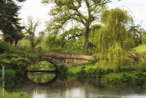Stunning landscape image of old medieval bridge over river with