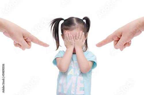 Little asian girl crying while parents scold her over white