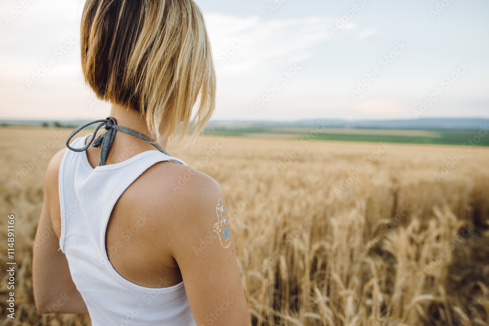 Carefree woman posing outdoor. Wheat field.