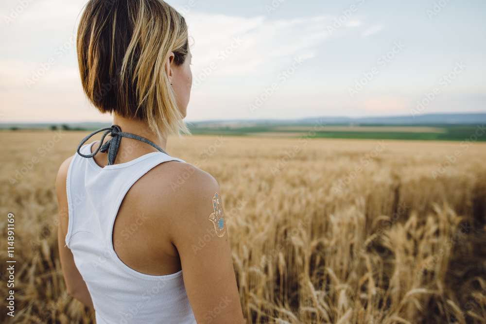 Carefree woman posing outdoor. Wheat field. Carefree woman posing outdoor. Wheat field.