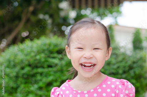 Cute asian little girl in park on summer day