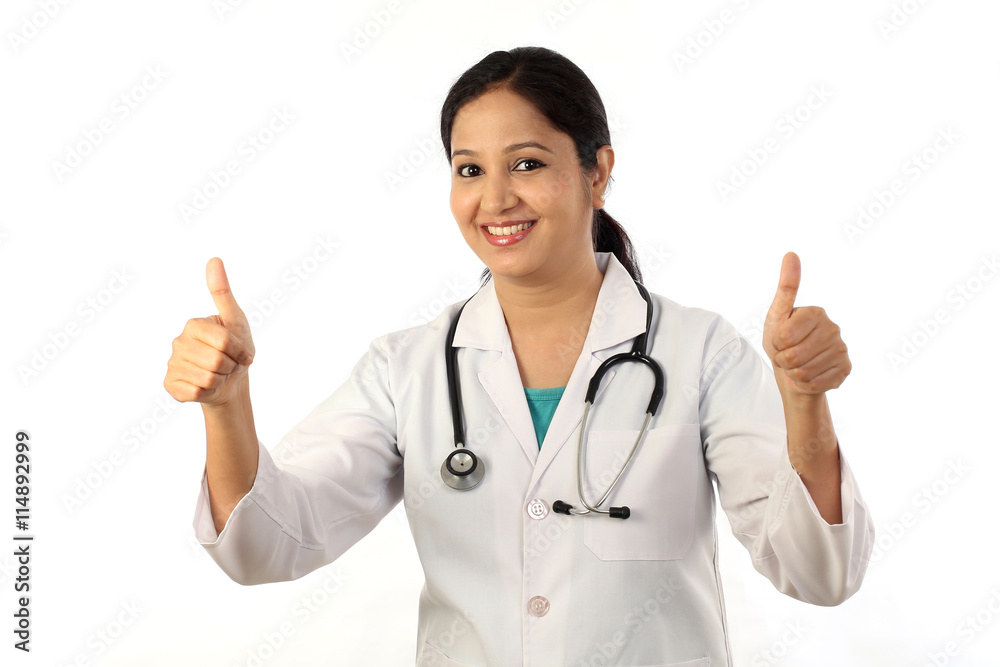 Young female doctor with thumbs up gesture Young female doctor with thumbs up gesture