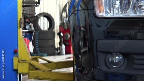 car lift up a car in service station garage