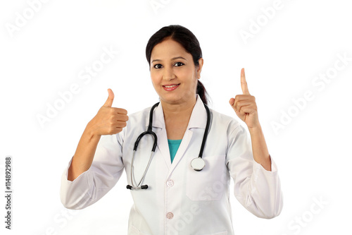 Young female doctor with thumbs up gesture