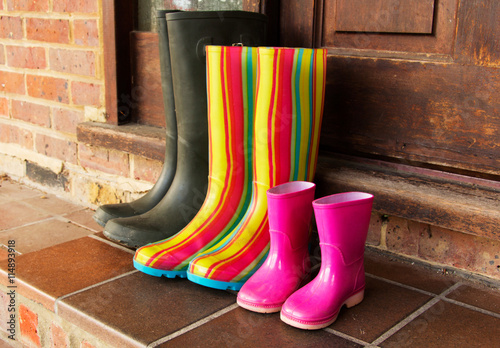 Colourful wellington boots left on a doorstep