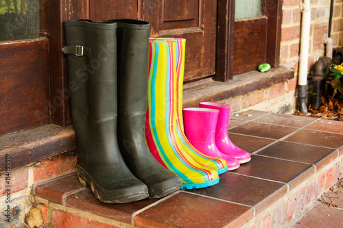 Colourful wellington boots left on a doorstep