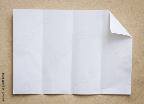 
Full page of White paper folded and wrinkled on wood brown background with shadow
