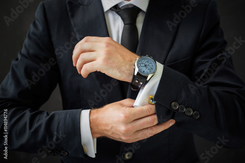 Fotografija Business man fixing his suit