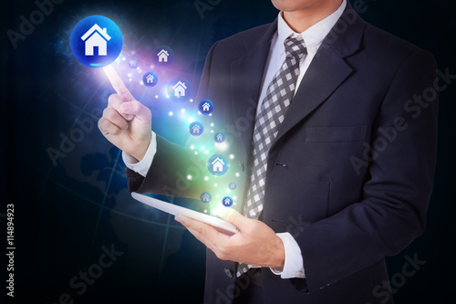 Businessman holding tablet with pressing home icon button. internet and technology concept
