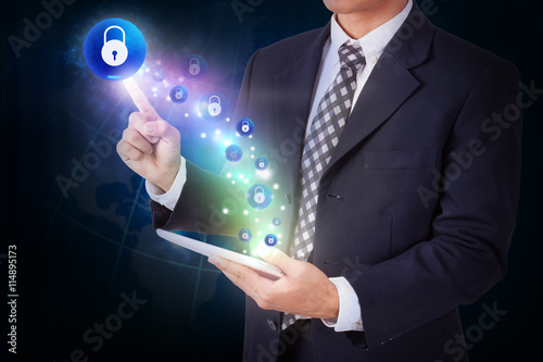 Businessman holding tablet with pressing lock icon button. internet and networking concept